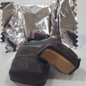 A chocolate covered peanut butter sandwich sitting on top of foil.