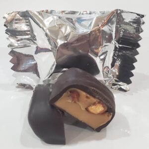 A close up of a chocolate covered peanut butter candy