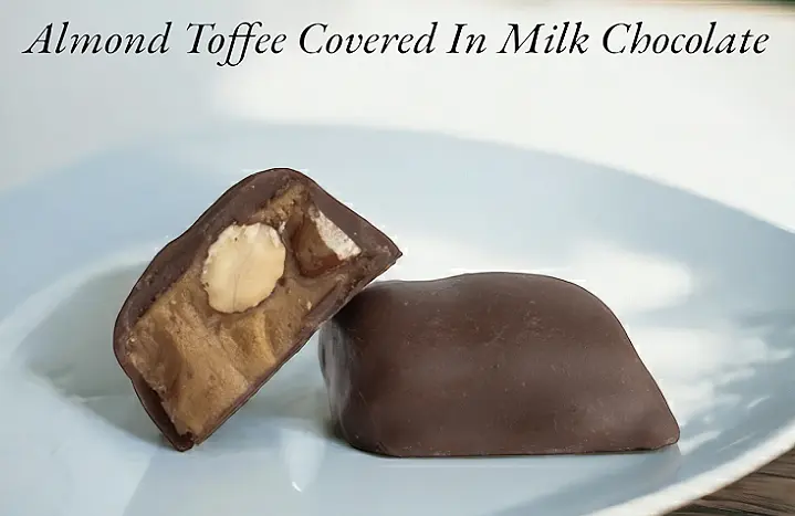 A close up of two chocolate covered candies